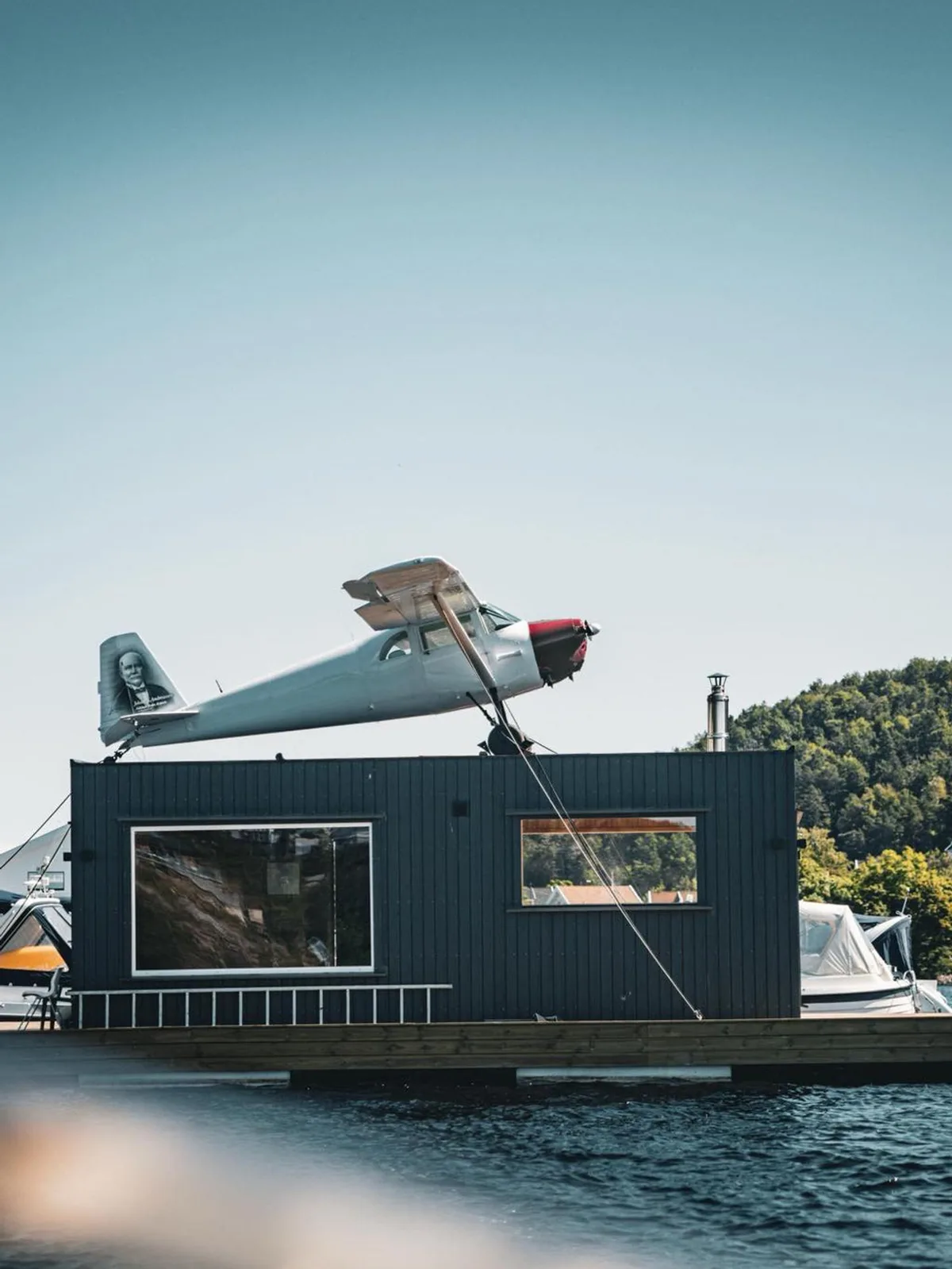 Arendal's Tyholmen old town with colourful wooden houses reflected in the calm harbour waters