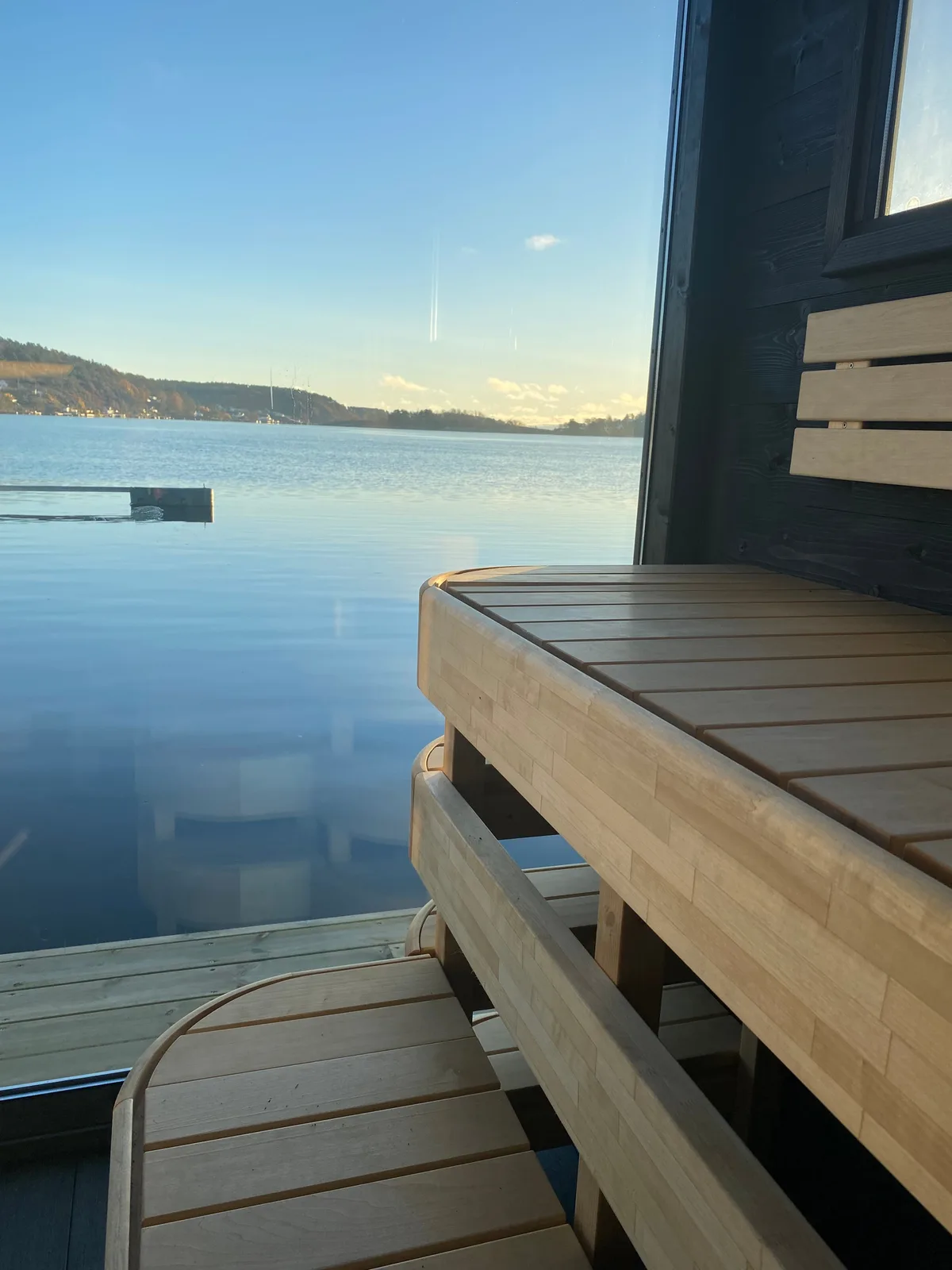Floating sauna on the harbour in Tønsberg with evening light over the Oslofjord