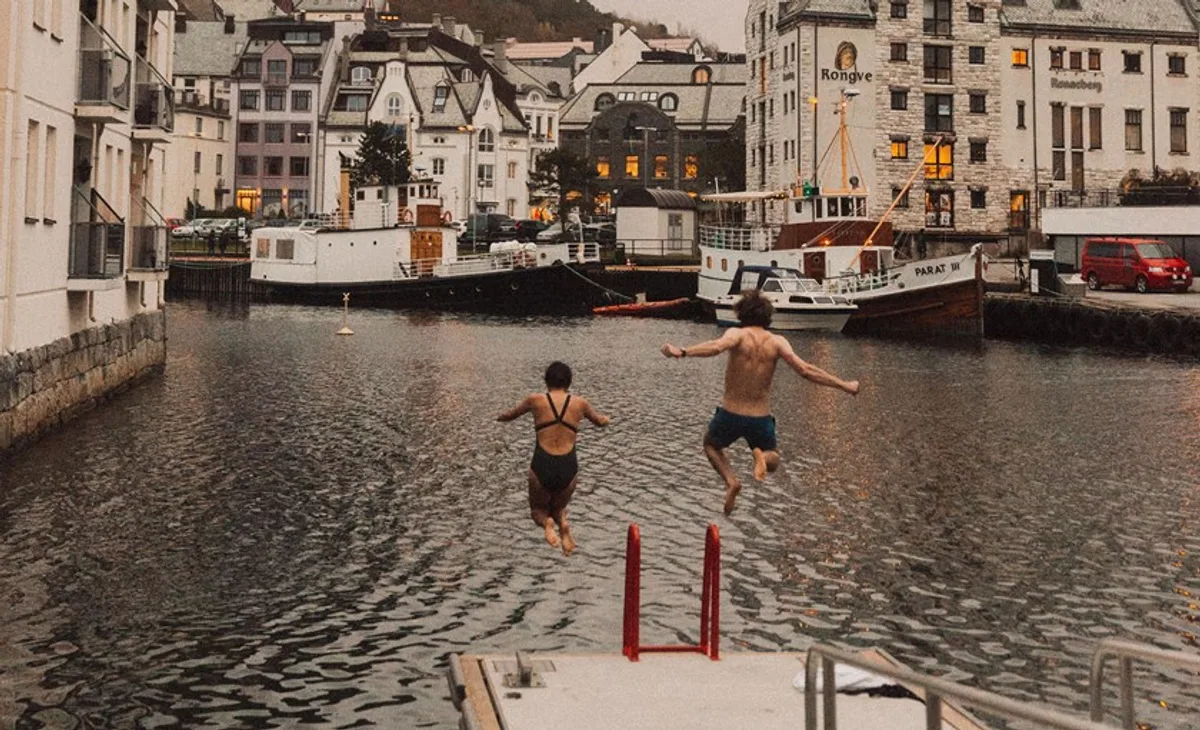 Aerial view of Ålesund's colorful Art Nouveau buildings reflected in the surrounding waterways